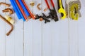 Installation of plastic pipes for the water system, pipe cutting tools, corners, holders, taps, adapters and work gloves on Royalty Free Stock Photo