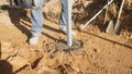 installation of post in fresh concrete on sunny ground, worker toasts support post with freshly poured concrete Royalty Free Stock Photo