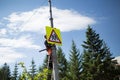 Installation road sign on pole. Road worker sets sign.