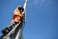 Installation road sign on pole. Road worker sets sign.