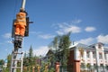 Installation road sign on pole. Road worker sets sign.