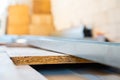 Installation of a rough first layer of oriented strand board flooring. Metal Y profile at a construction site on a blurred Royalty Free Stock Photo