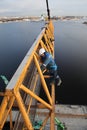 Installation section of tower crane at height, assembly fitters steeplejacks.