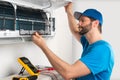 Installation service fix repair maintenance of an air conditioner indoor unit, by cryogenist technican worker checking the air