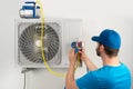 Installation service fix repair maintenance of an air conditioner outdoor unit, by cryogenist technican worker evacuate the