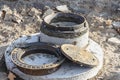 Installation of a sewer ring with a cast-iron hatch when repairing a road. Drainage well with a round metal hatch