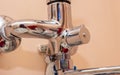 Installation of the spout of the water tap in the bathroom. Screwing in the nut of the water mixer. Royalty Free Stock Photo