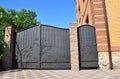 Installation of Stone and Fence with Door and Gate for Car. Security CCTV camera is mounted on a brick house wall. Royalty Free Stock Photo