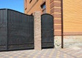 Installation of Stone and Metal Fence with Door and Gate.