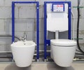 Installation systems for toilets and bidets