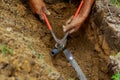 Man Applying Solvent Primer and Cement to PVC Pipes as Part of Installation of Underground automatic Sprinkler System Royalty Free Stock Photo