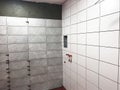 Installation of Wall Tiles in a Renovation Project Featuring Gray and White Ceramic Tiles with Precise Alignments and Fixtures Royalty Free Stock Photo
