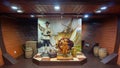 Installation of a wax figure of a traveler in the hold of an old sailing ship next to the helm of the ship