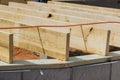 Installation of wood floor joist trusses on a concrete block foundation