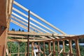 Installation of wooden beams at construction the roof truss syst Royalty Free Stock Photo