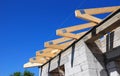 Installation of wooden beams at construction the roof truss system of the house