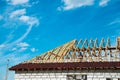 Installation of a wooden roof and Closing the roof with Onduvilla bituminous tiles. Woods elements and components of the Royalty Free Stock Photo