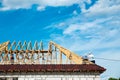 Installation of a wooden roof and Closing the roof with Onduvilla bituminous tiles. Woods elements and components of the Royalty Free Stock Photo