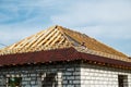 Installation of a wooden roof and Closing the roof with Onduvilla bituminous tiles. Woods elements and components of the Royalty Free Stock Photo