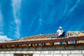 Installation of a wooden roof and Closing the roof with Onduvilla bituminous tiles. Woods elements and components of the Royalty Free Stock Photo