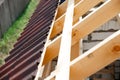 Installation of a wooden roof and Closing the roof with Onduvilla bituminous tiles. Woods elements and components of the Royalty Free Stock Photo