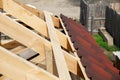 Installation of a wooden roof and Closing the roof with Onduvilla bituminous tiles. Woods elements and components of the Royalty Free Stock Photo