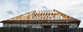 Installation of a wooden roof and Closing the roof with Onduvilla bituminous tiles. Woods elements and components of the Royalty Free Stock Photo