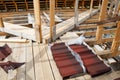 Installation of a wooden roof. Packaging of Onduvilla Bituminous tiles, lying on a construction site.Woods elements and components Royalty Free Stock Photo