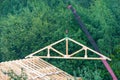 Installation of wooden structures,truss on the roof with a crane.Concept of construction,installation hazards