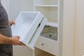 Installation of workman sets the drawer in closet cabinet