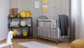 Installation with yellow and black bees above grey wooden crib with blanket and pillow