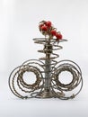 Installations  candelabra  of three antique furniture springs and  rosehip branch like flame Royalty Free Stock Photo