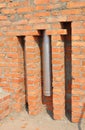 Installed in brick wall metal chimney for fireplace. Stainless steel chimney stove pipe installation. Royalty Free Stock Photo