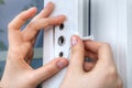Installer hands close-up, installation of limiter pvc window. Royalty Free Stock Photo