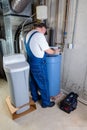 Installer inputting settings on a water softener Royalty Free Stock Photo