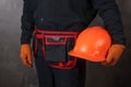 Installer in a special uniform with a helmet in hand