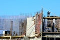 Installers against the blue sky collect metal structures