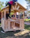 Installers build a pavilion of wood material