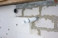 Installing anchors in house wall for rigid insulation foam in smoke pipe problem area Royalty Free Stock Photo