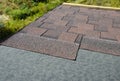 Installing brown dimensional asphalt roof shingles on the underlayment water-resistant waterproof protection barrier material on