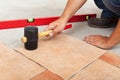Installing ceramic flooring - fitting a tile Royalty Free Stock Photo