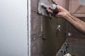 Installing ceramic wall tiles with tile levelers Royalty Free Stock Photo