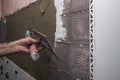 Installing ceramic wall tiles with tile levelers Royalty Free Stock Photo