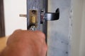 Installing door handle with lock, locksmith fixes bolt on latch plate