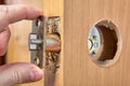 Installing door latch plate with lock assembly