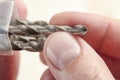 Installing a drill bit in a drill, hands take a drill and install it in a cordless drill chuck Royalty Free Stock Photo