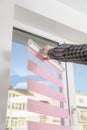 Installing fabric roller blinds. Royalty Free Stock Photo