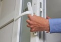 repair of plastic doors,installing a handle on a PVC door, a locksmith repairs a door lock Royalty Free Stock Photo