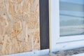 Installing house PVC window with waterproofing membrane and insulation for house energy saving