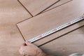 Installing laminate flooring in a room or office. Wooden parquet boards in the hands of a worker. Construction and Royalty Free Stock Photo